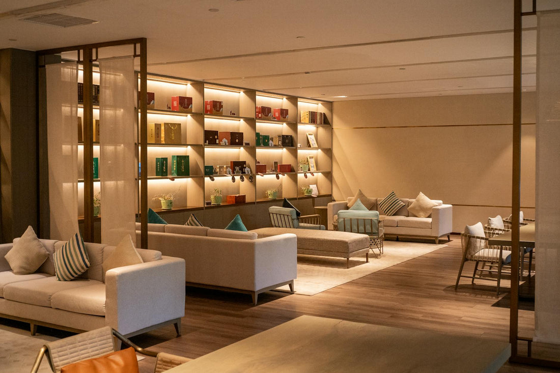 Modern hotel lounge with cozy seating and illuminated shelves in Hangzhou, China.