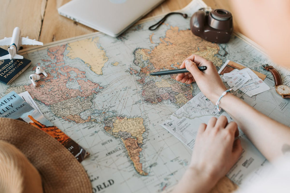 Hands planning a private China itinerary with a map and destination notes