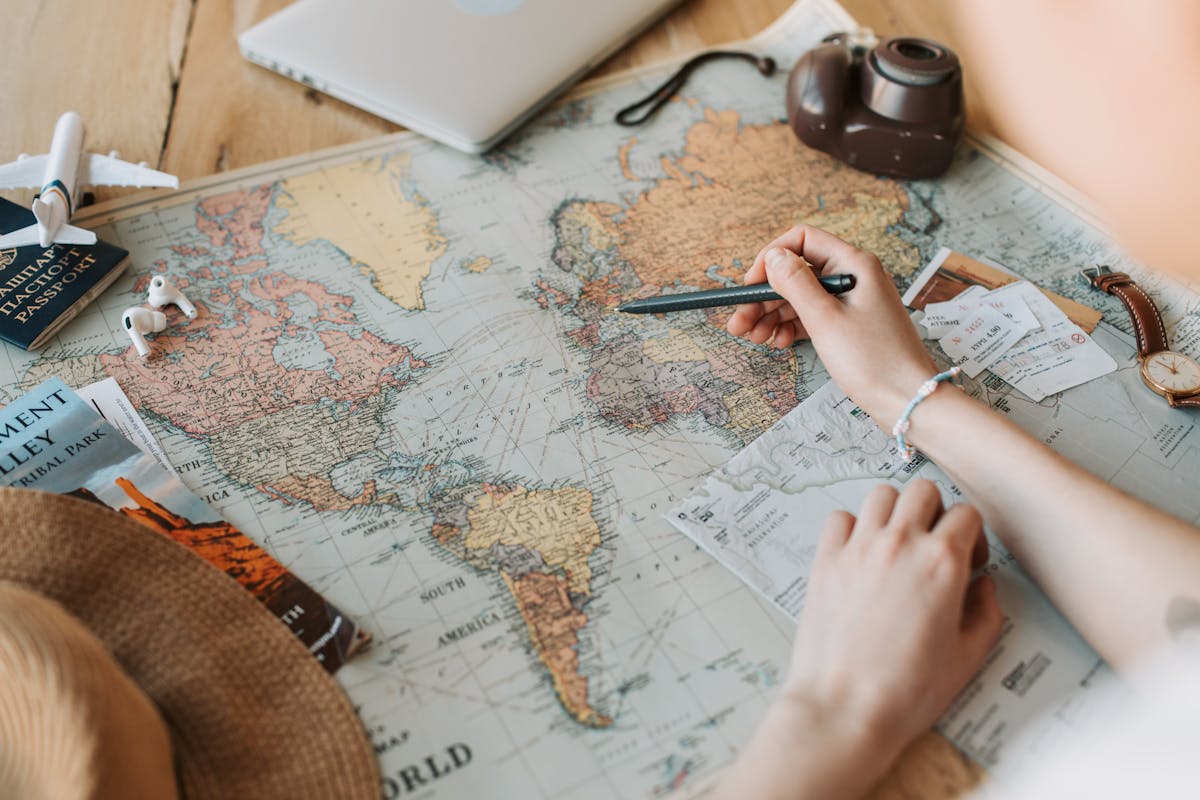 Hands planning a private China itinerary with a map and destination notes