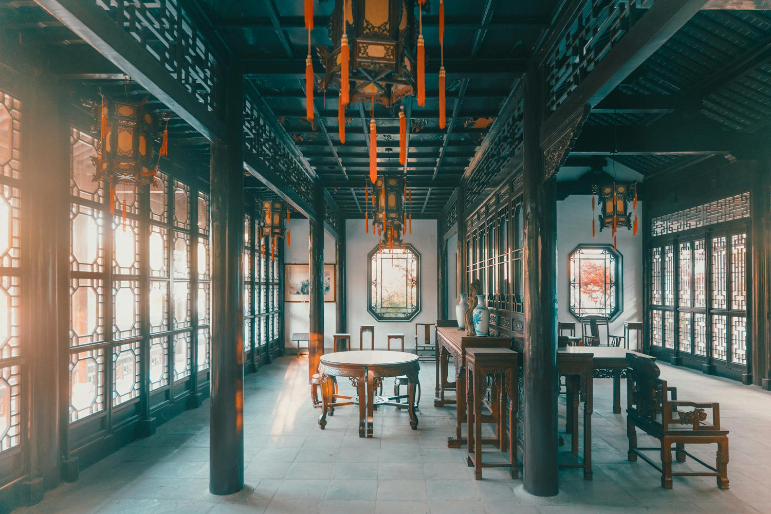 Traditional Chinese room with intricate wood carvings and lanterns, exuding a classic aesthetic.